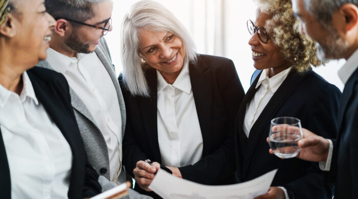 Multiracial business people working inside bank office - Focus on senior woman face