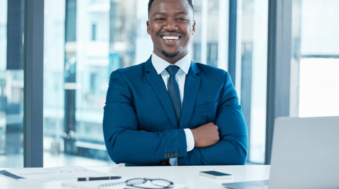 Portrait of a confident young businessman working at his desk in a modern office.