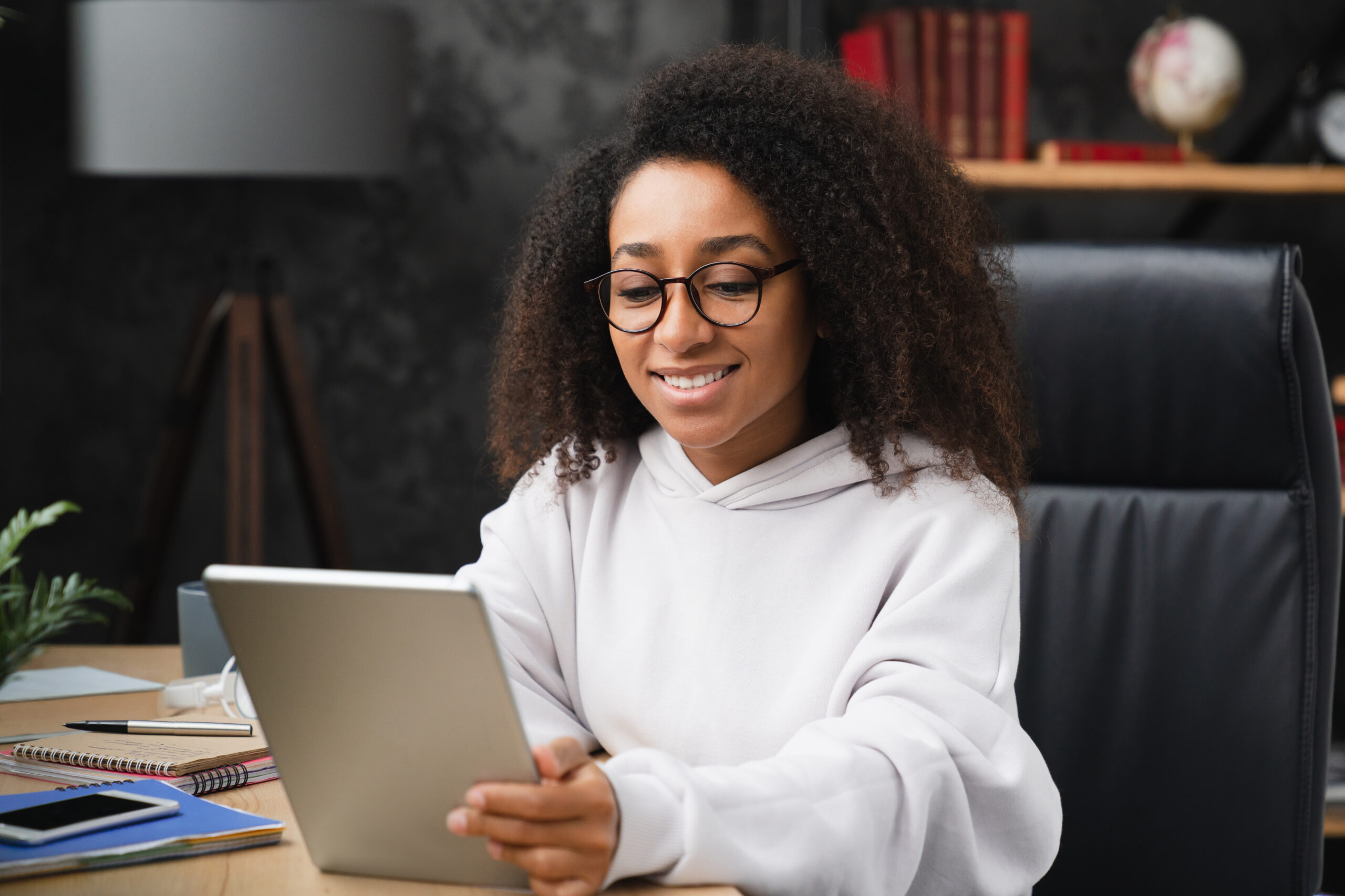 Schoolgirl Using Digital Tablet At Home, Doing Homework Assignment Online, Browsing Social Media