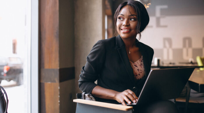 African American Business Woman Working On A Computer In A Bar