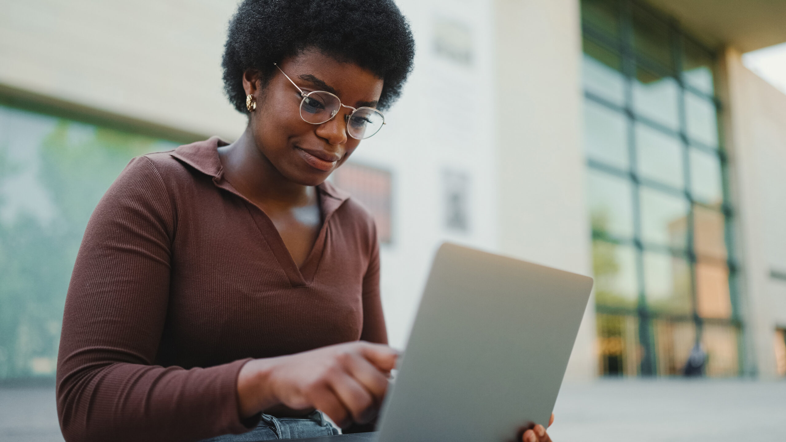 Female Entrepreneur Working On Laptop Outdoors. African American