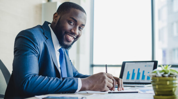 smiling-businessman-signing-contract