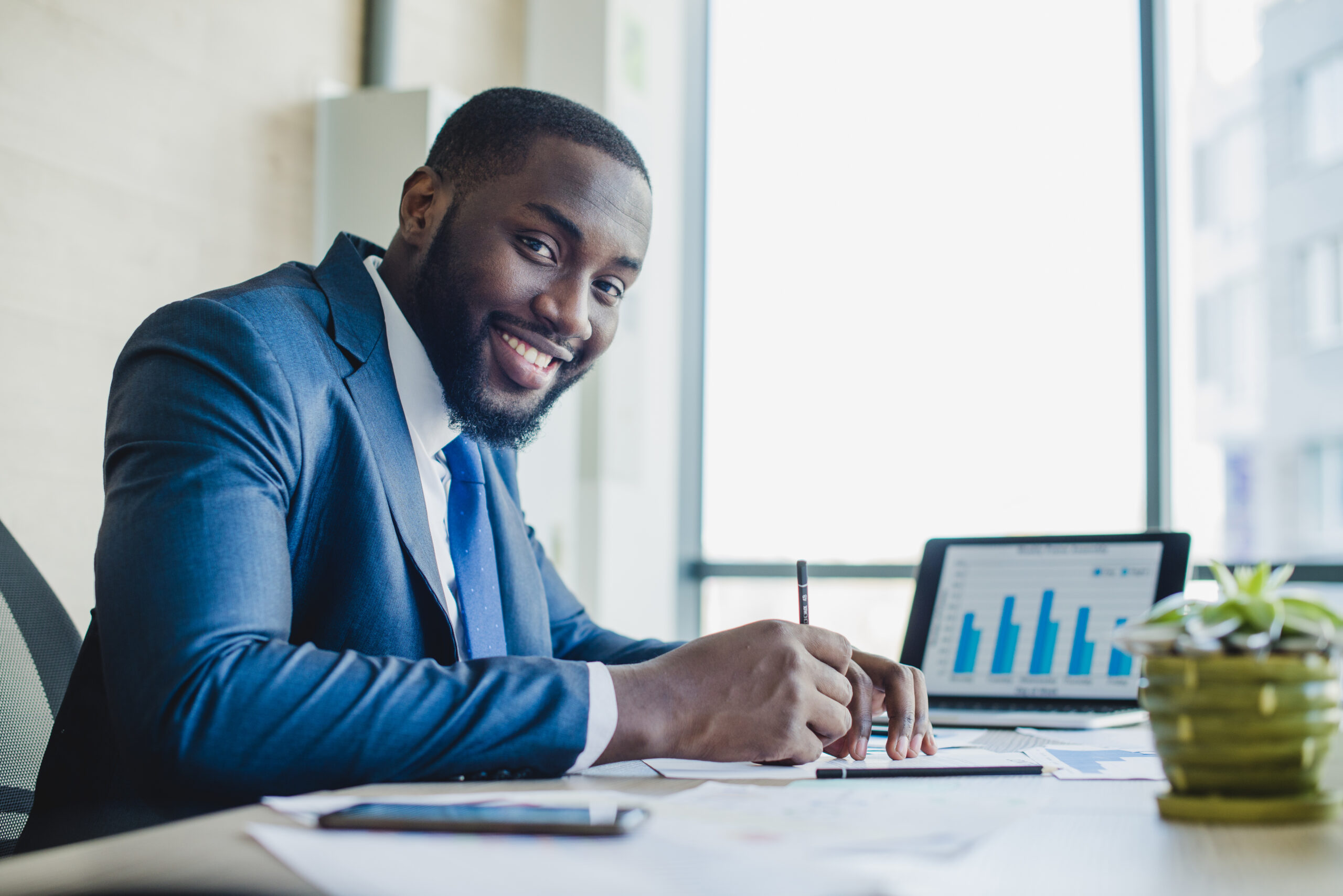 Smiling Businessman Signing Contract